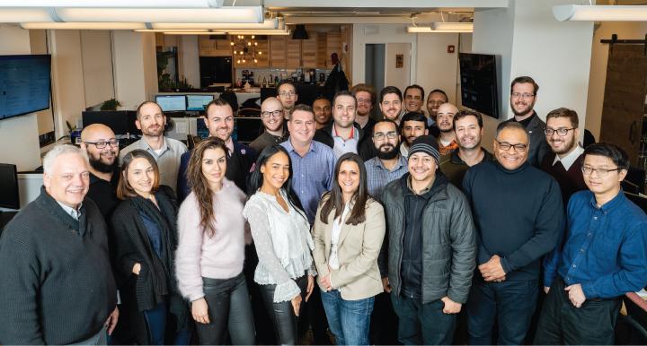 Acrisure Cyber Services team gathered in a modern office