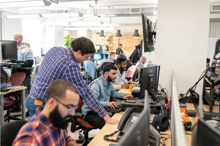 Acrisure Cyber Services team members collaborating in an office